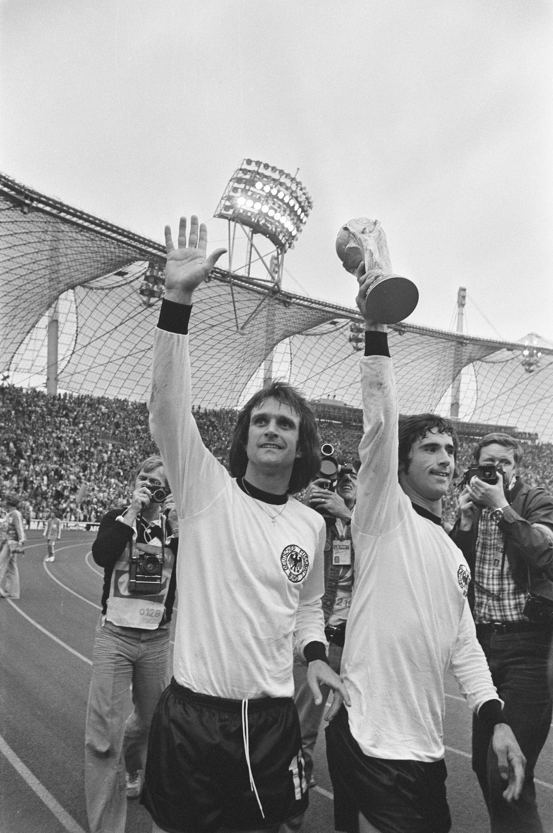 Wolfgang Overath (left) and Gerd Müller (right, holding the trophy) at the Olympiastadion after West Germany's 2-1 win over the Netherlands in the 1974 World Cup final, Munich: the occasion itself, after the match